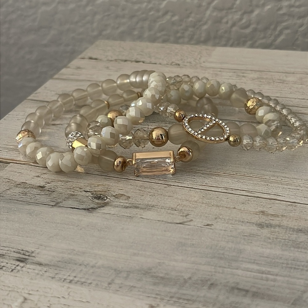 Off White/Smoky Beaded Four Strand Stretchy Gem/Charm Bracelet. - Picture 3 of 4